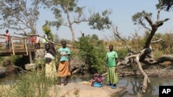 Women stand between the borders of Uganda and South Sudan near Bibi Bidi, Uganda. Thousands of refugees have fled South Sudan into Uganda, creating huge refugee settlements, Dec. 11, 2016.
