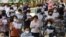 People wearing face masks to help protect against the spread of the coronavirus pray while maintaining social distancing during a service at the Chogyesa temple in Seoul, South Korea, Sunday, Aug. 23, 2020. (AP Photo/Ahn Young-joon)