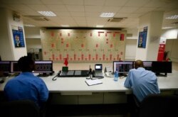 FILE - Engineers work in the control room of Gibe III hydroelectric dam in Shoma Yero village in Southern Nations, Nationalities, and Peoples' Region in Ethiopia, Dec. 16, 2016.