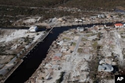 FILE - Devastation from Hurricane Michael is visible including the area around Bonny Paulson's home, center top, in Mexico Beach, Fla., Friday, Oct. 12, 2018. (AP Photo/Gerald Herbert)