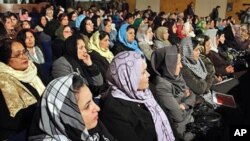 Afghan women listen to Afghan President Hamid Karzai, during a speech about women's rights, in Kabul.