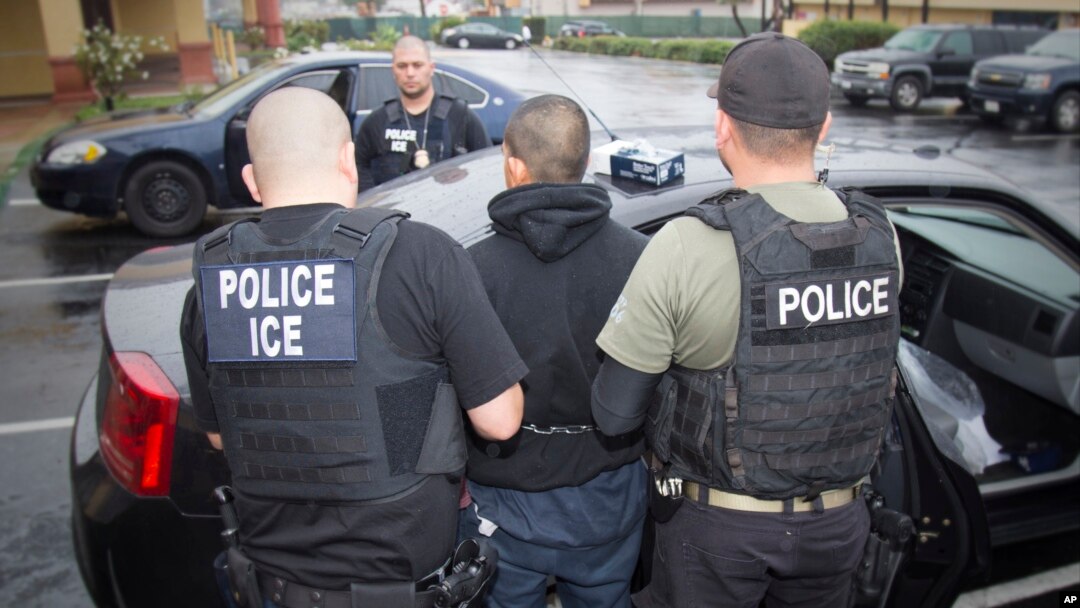 FILE - This photo released by U.S. Immigration and Customs Enforcement shows foreign nationals being arrested during a targeted enforcement operation aimed at immigration fugitives, re-entrants and at-large criminal aliens in Los Angeles, Feb. 7, 2017. 