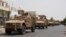Yemeni fighters against Shiite rebels ride military vehicles on a street in the port city of Aden, July 14, 2015.