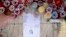 FILE - Candles, notes and paper cuttings lie next to the Love Monument in St. Julian, Malta, Oct. 17, 2017 the day after the killing of journalist Daphne Caruana Galizia.