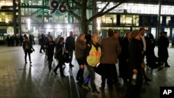 Spectators leave the HDI Arena after cancellation of an exhibition football match between Germany and the Netherlands because of a bomb threat in Hanover, Germany, Nov. 17, 2015.