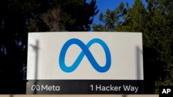 FILE - Meta's logo can be seen on a sign at the company's headquarters in Menlo Park, Calif., Nov. 9, 2022. 