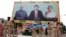 Police stand guard in front of a bill board with images of (L-R) India's Prime Minister Narendra Modi, China's President Xi Jinping and Anandiben Patel, Chief Minister of the western Indian state of Gujarat, ahead of Xi's arrival, in Ahmedabad, Sept. 16, 