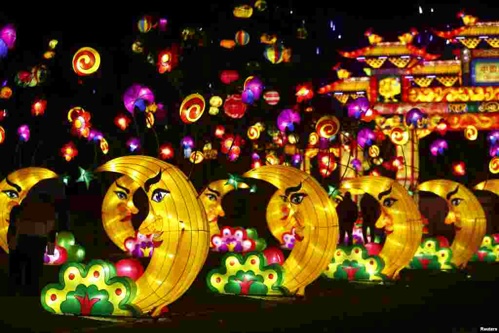 People attend the Dandenong Festival of Lights in the suburb of Dandenong in Melbourne, Australia. The month-long festival, set up by the Chinese Cultural Works Light Spectacular, celebrates Chinese culture through a display of hundreds of beautiful and unique silk light displays, according to the event&#39;s website.