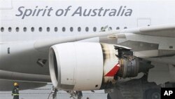 Firefighters surround a Qantas passenger plane which made an emergency landing in Singapore's Changi International Airport after having engine problems, 04 Nov 2010