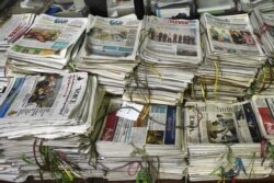FILE - Various local newspapers are stacked in files at the newsroom of privately owned Myanmar Times newspaper in Yangon, Oct. 11, 2018.