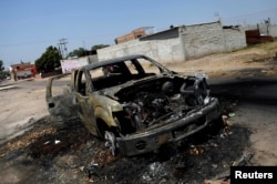 The wreckage of a car that was burnt in a blockade set by members of the Santa Rosa de Lima Cartel to repel security forces during an anti-fuel theft operation is pictured in Santa Rosa de Lima, in Guanajuato state, Mexico, March 6, 2019.