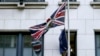 A member of protocol removes the European Union flag from the U.K. Permanent Representation to the EU in Brussels, Jan. 31, 2020.