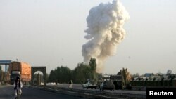 Smoke rises from the site of a bomb attack on a base operated by Polish and Afghan forces in Ghazni province, Afghanistan, Aug. 28, 2013.