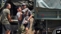 FILE - Philippine troopers load artillery during a joint military exercise on May 8, 2024, in Laoag, Ilocos Norte, northern Philippines. 