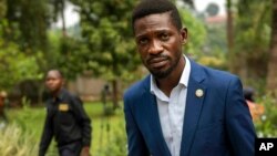 Uganda's leading opposition challenger Bobi Wine walks back to his residence after giving a press conference outside Kampala, Uganda, Jan. 15, 2021, one day after Ugandans went to the polls. 