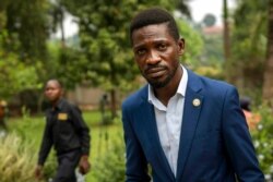 Uganda's leading opposition challenger Bobi Wine walks back to his residence after giving a press conference outside Kampala, Uganda, Jan. 15, 2021, one day after Ugandans went to the polls.