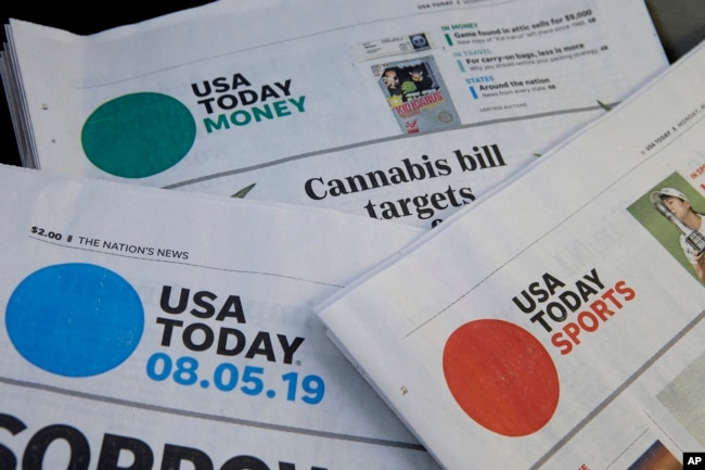 FILE - Sections of a USA Today newspaper on display, Aug. 5, 2019, in Norwood, Mass. USA Today and Gannett newspapers are testing artificial intelligence tools. (AP Photo)