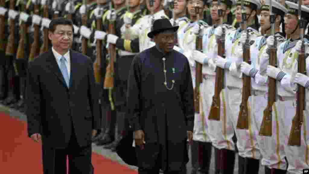 Chinese President Xi Jinping and President Jonathan review an honor guard during a welcome ceremony at the Great Hall of the People in Beijing.