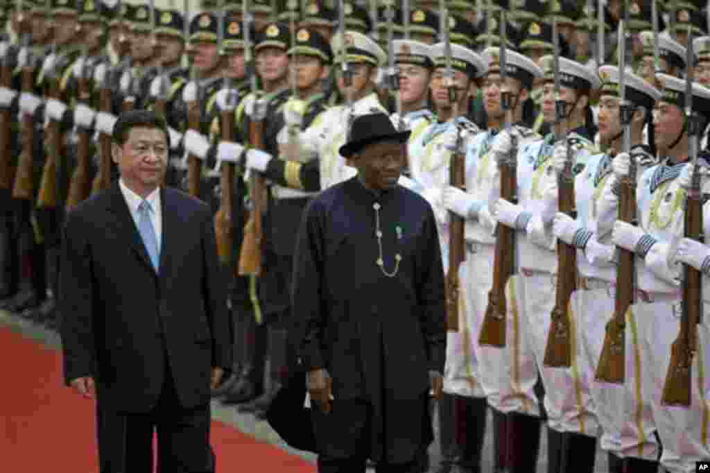 Chinese President Xi Jinping and President Jonathan review an honor guard during a welcome ceremony at the Great Hall of the People in Beijing.