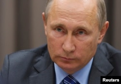 FILE - Russian President Vladimir Putin says U.S. authorities should pay more attention to the content of recently stolen emails, instead of who had hacked into computers and exposed them.