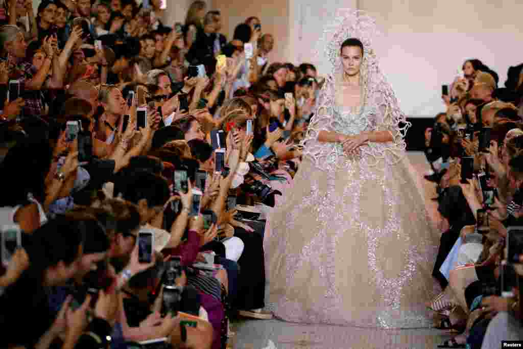 A model presents a wedding dress by designer Elie Saab as part of Saab&#39;s Haute Couture Fall/Winter 2018/2019 fashion show in Paris, France.