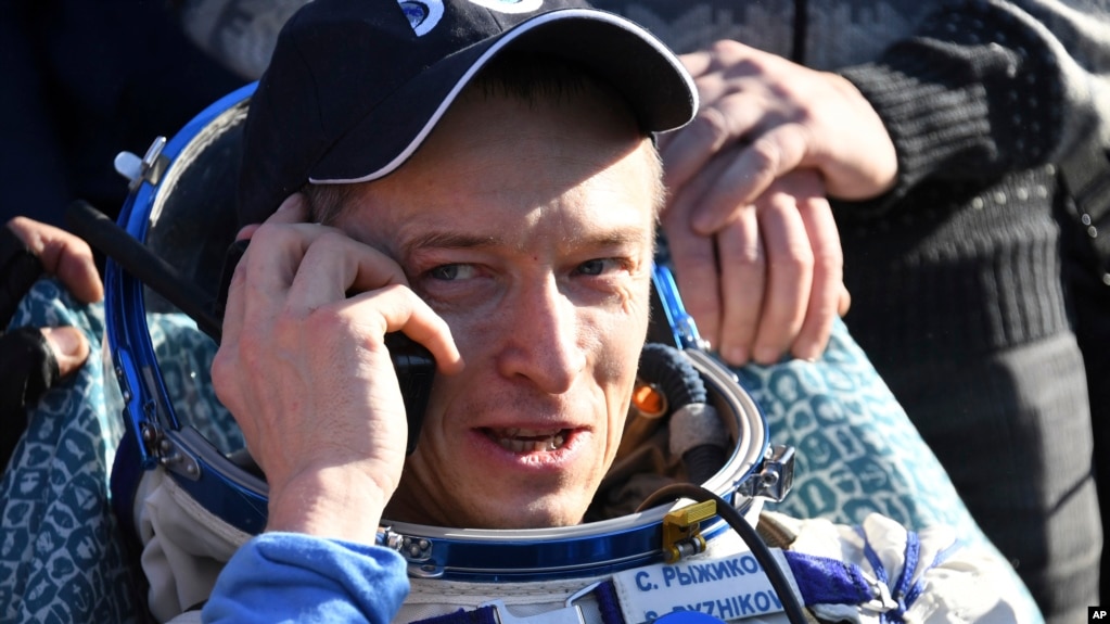 Russian cosmonaut Sergey Ryzhikov uses a sat phone shortly after landing near Dzhezkazgan, Kazakhstan Monday, April 10, 2017, on the treeless Central Asian steppes Russia's Soyuz MS-02 space capsule carrying the International Space Station (ISS) crew of Andrei Borisenko and Sergey Sergei Ryzhikov of Russia and NASA astronaut Robert Shane Kimbrough landed in a remote area in Kazakhstan. 