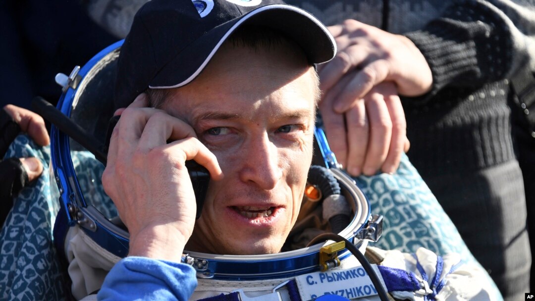Russian cosmonaut Sergey Ryzhikov uses a sat phone shortly after landing near Dzhezkazgan, Kazakhstan Monday, April 10, 2017, on the treeless Central Asian steppes Russia's Soyuz MS-02 space capsule carrying the International Space Station (ISS) crew of Andrei Borisenko and Sergey Sergei Ryzhikov of Russia and NASA astronaut Robert Shane Kimbrough landed in a remote area in Kazakhstan. 
