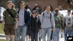 FILE - Students walk across campus at the University of Vermont in Burlington, Vermont.