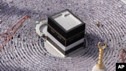 FILE - Muslim pilgrims pray around the Kaaba, the cubic building at the Grand Mosque, during the annual Hajj pilgrimage in Mecca, Saudi Arabia, on June 25, 2023. Temperatures will be above-average again for the 2024 Hajj, which begins on June 24.