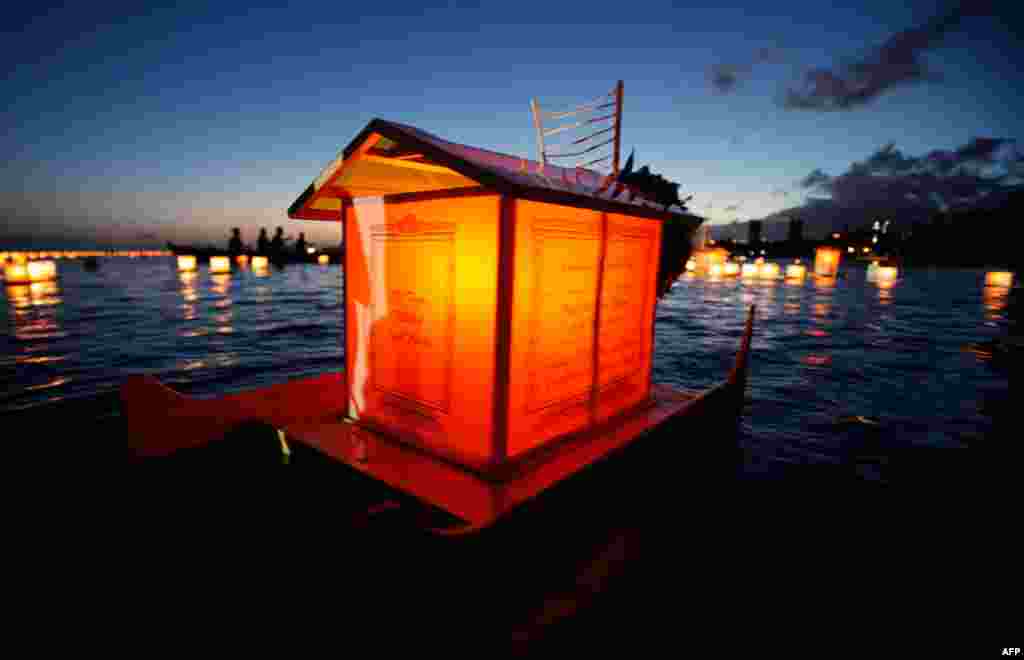 May 30: A lantern dedicated to victims of war, natural disasters and health floats on the water during the Na Lei Aloha Lantern Floating event held by the Shinnyo-en Buddhist at Ala Moana beach park on Memorial Day in Honolulu, Hawaii. (Reuters)