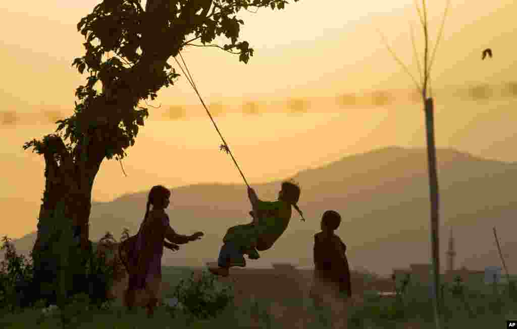 Pakistani children enjoy playing on the outskirts of Islamabad, Pakistan. 