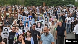 People take part in a commemoration ceremony marking the 20th anniversary of the deadly school siege, at a cemetery in Beslan in the region of North Ossetia–Alania, Russia Sept.3, 2024.