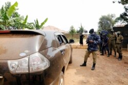 Ugandan police officers refuse lawyers of Ugandan opposition presidential candidate Robert Kyagulanyi, also known as Bobi Wine, from meeting him at his house in Kampala, Jan. 18, 2021.