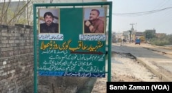 A roadside sign leading to Dhola village, Gujarat district, Pakistan, commemorates Chaudhry Atif Morsi and Chaudhry Sufyan Gorsi as martyrs, Feb. 4, 2025. The men died on a stranded boat in the Atlantic Ocean on their way from Mauritania to Spain’s Canary Islands in January.