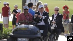 FILE - Donald Trump drives himself around a golf course in Doral, Florida, March 6, 2016. Even thought the White House released no detailed accounting of much of President Trump's schedule over the weekend, according to a source, he played 18 holes Saturd