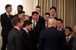 President Donald Trump talks with members of the University of Wisconsin-Madison Women's Hockey Team during the NCAA Collegiate National Champions Day at the White House, Nov. 22, 2019.