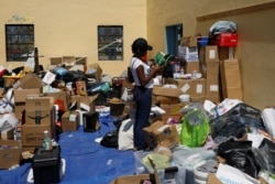 A volunteer looks for supplies at an airport during an evacuation operation after Hurricane Dorian hit the Abaco Islands in Treasure Cay, Bahamas, Sept. 7, 2019.