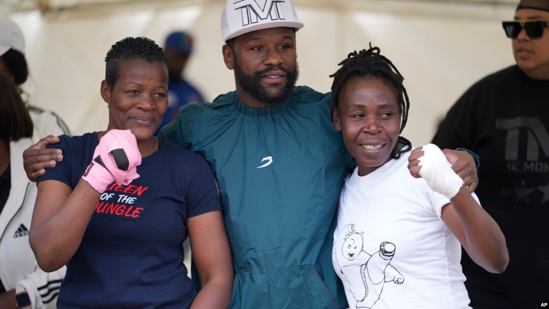 FILE - U.S boxing promoter and former professional boxer Floyd Joy Mayweather, center, poses for a picture with women boxers at an event on the outskirts of the capital Harare, Zimbabwe Thursday, July 13, 2023.