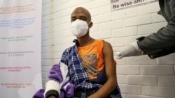 FILE PHOTO: A volunteer receives an injection from a medical worker during the country's first human clinical trial for a potential vaccine against the novel coronavirus, in Soweto