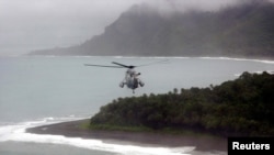 FILE - Australian helicopter flies low across the Weathercoast of the Solomon Islands.