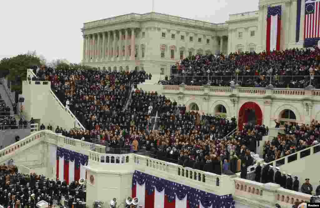 U.S. Supreme Court Chief Justice John Roberts (2nd from R, front) administers the oath of office to U.S. President Barack Obama as first lady Michelle Obama (C, front) and daughters Malia and Sasha (R, front)