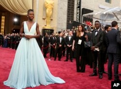 Lupita Nyong'o arrives at the Oscars in Los Angeles, March 2, 2014. Nyong'o, wearing a light blue Prada gown, won the Oscar for best supporting actress for her role in "12 Years a Slave."