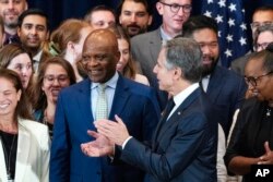 FILE—John Nkengasong, new head of the Bureau of Global Health Security and Diplomacy at the State Department, center left, is applauded by Secretary of State Antony Blinken at the State Department, August 1, 2023, at the State Department in Washington.