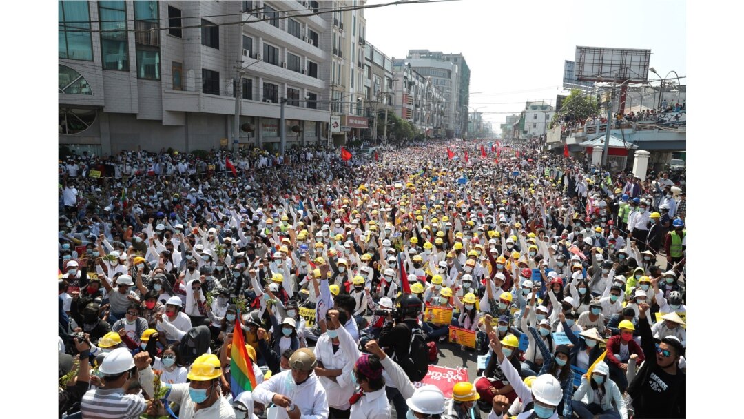 Anti-coup protesters raise their hands with clenched fists during a nationwide general strike near the Mandalay Railway Station in Mandalay, Myanmar, Feb. 22, 2021, to protest against the military coup.