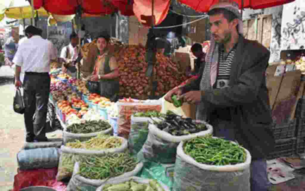 A street vendor sells food on the streets of the capital San'a, Yemen. Even in Yemen's breadbasket, people are having trouble feeding themselves in what food experts say is a hidden but growing hunger problem across this impoverished country, the poorest 