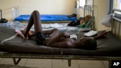 A child suffering from the Ebola virus receives treatment at Makeni Arab Holding Centre in Makeni, Sierra Leone, Saturday, Oct. 4, 2014. Makeni is one of three districts recently quarantined by the government. (AP Photo/Tanya Bindra)