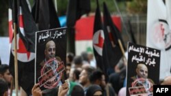 Former detainees of the pro-Israel South Lebanon Army (SLA) militia hold posters depicting former SLA member Amer Fakhoury during a demonstration denouncing his return, outside the Justice Palace in the Lebanese capital, Beirut, Sept. 12, 2019. 