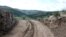 View of a dirt road passing through a damaged section of the Great Wall of China, in Youyu County, Shuozhou City, Shanxi Province, China, in this still image released on Aug. 31, 2023.    Youyu County Public Security Bureau/Handout via REUTERS.  