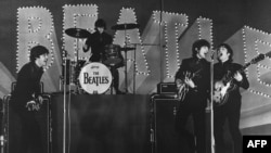 This photo taken on June 30, 1966 shows British band The Beatles, left to right, Paul McCartney, Ringo Starr, George Harrison and John Lennon, performing during their concert at the Budokan in Tokyo.