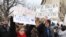 Protesters carry signs outside the White House during a protest to denounce President Donald Trump's executive order that blocks the arrival of all refugees to the United States, Sunday, Washington, Jan. 29, 2017. (Photo: S. Islam/VOA)